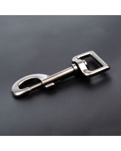 A dark gray gunmetal snap hook on a black background