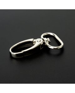 A silver nickle lobster clip on a black background