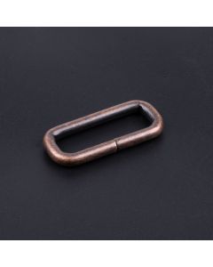1 1/2 Inch Antique Copper Heavy Welded Rectangle Ring with a dark background